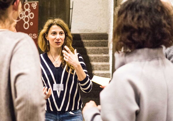 Eine junge Frau spricht zu anderen Menschen